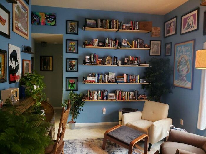 blue room with painting and white chair 