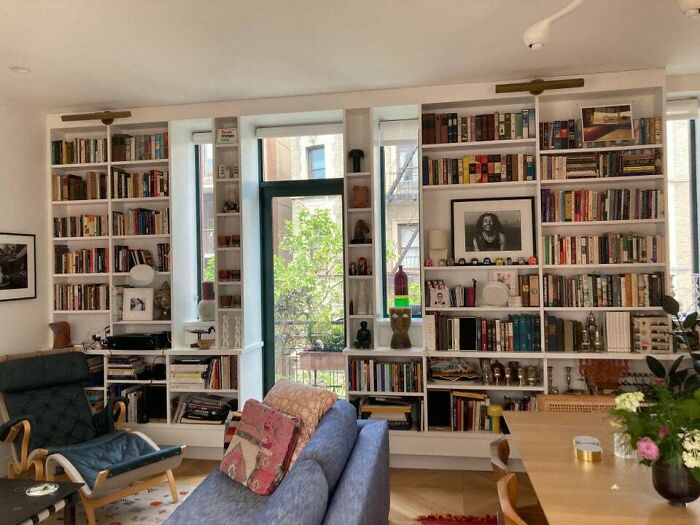 Blue couch, white bookshelves 