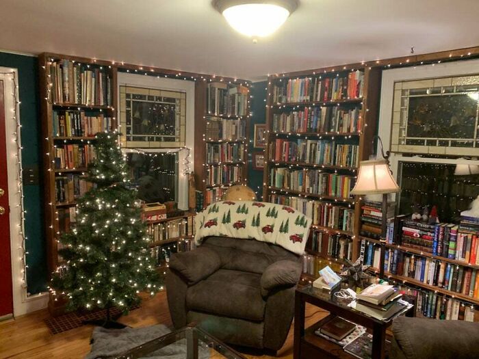 brown chair next to a christmas tree 