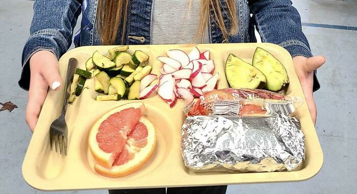 Girl holding plate with vegetables and fruits