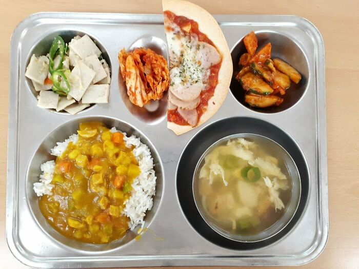 Plate with soup, vegetables, rice and meat