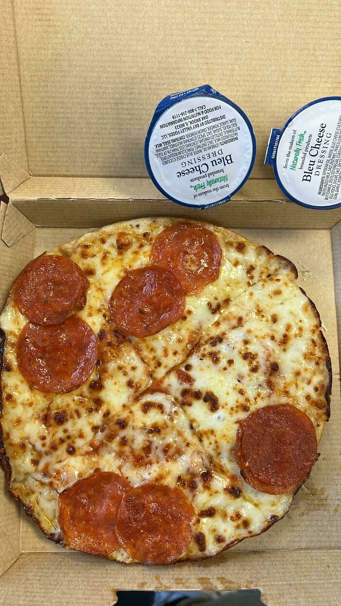 Cooked pizza with sausages and cheese