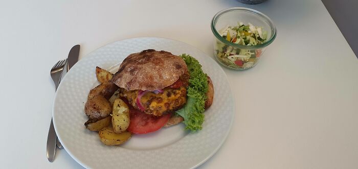 Plate with burger, vegetables, potatoes