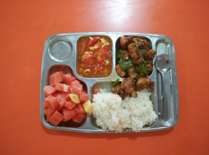 Plate with rice, chicken, vegetables and fruit