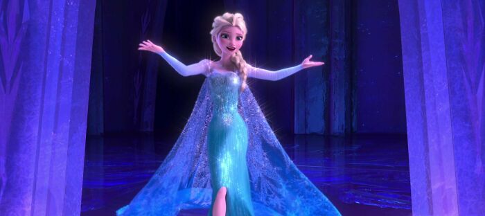 Female cartoon character in a shimmering blue gown, arms outstretched in a snowy, magical setting.