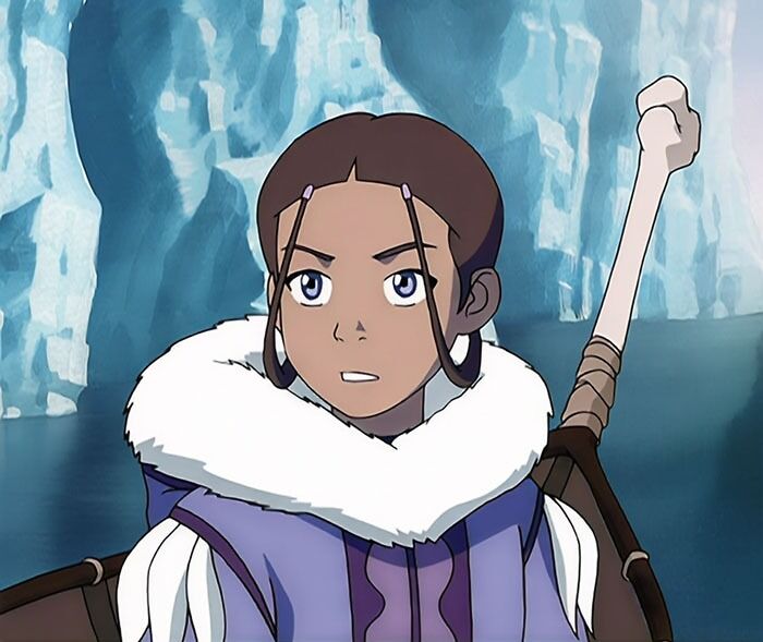Female cartoon character with a fur collar, holding a staff, exudes fame and strength against an icy backdrop.