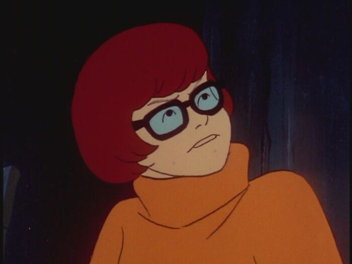 Female cartoon character with glasses and orange sweater, showcasing fame and strength.