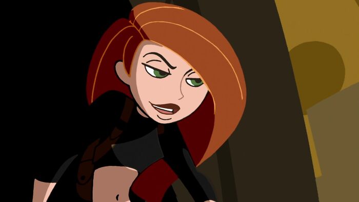 Female cartoon character with red hair, wearing a black outfit, showcasing strength and confidence.