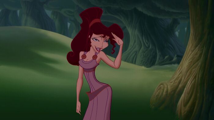 A strong female cartoon character with red hair poses confidently in a forest setting.