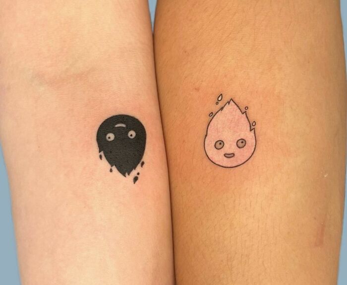 Two minimal tattoo designs on forearms, featuring a solid black droplet and an outlined pink flame character.
