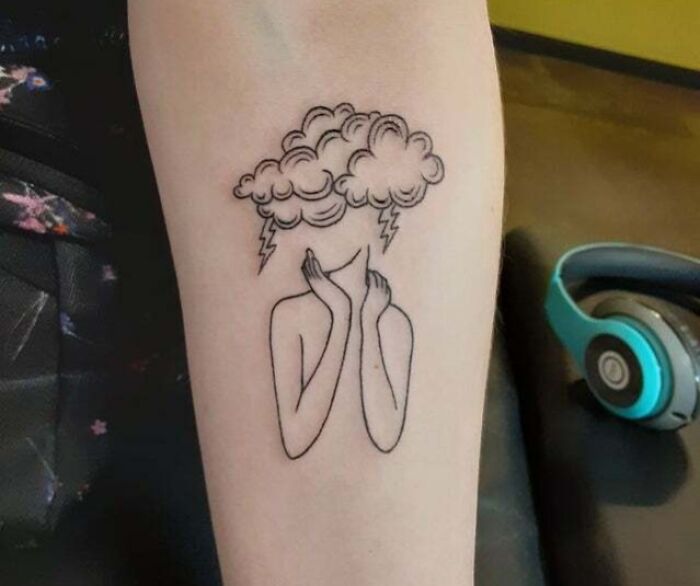 Minimal tattoo design of a person with a cloud and lightning bolts on their head.