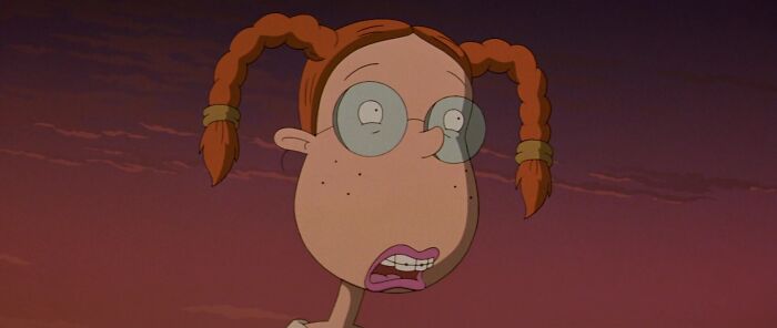 Red-haired female cartoon character with glasses, showcasing fame and strength.