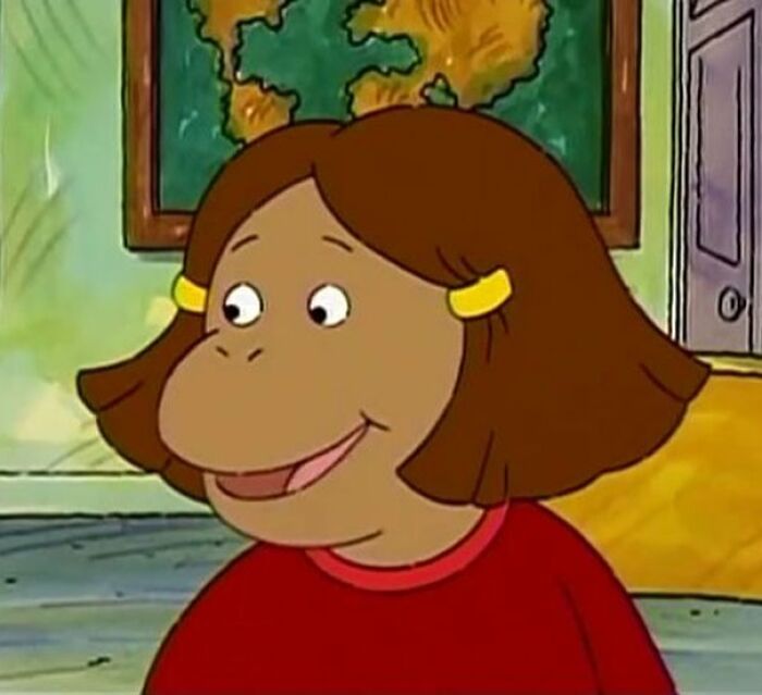 Female cartoon character with brown hair, wearing a red shirt, showcasing fame and strength.