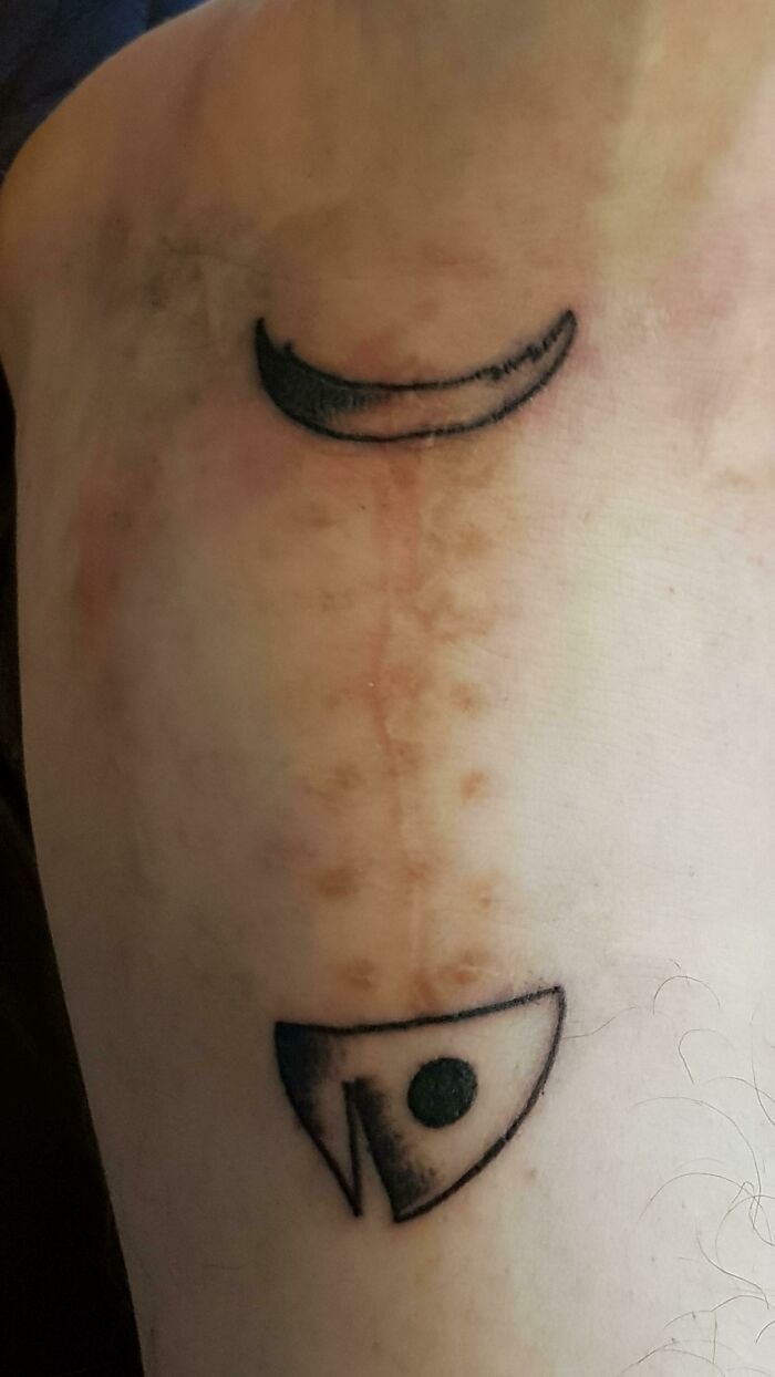 Funny tattoos featuring two minimalist smiling symbols on skin.