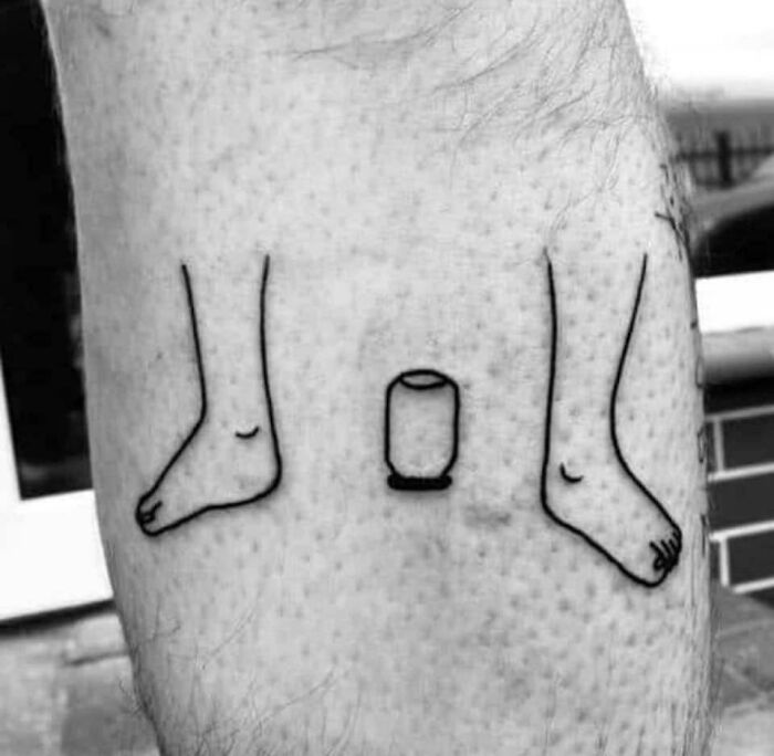 Funny tattoo of cartoon legs and a can on the calf, designed to make you smile.