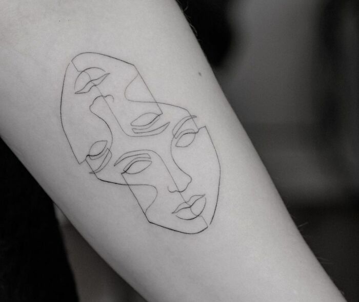 Fine-line single-line tattoo, abstract overlapping faces design on arm.