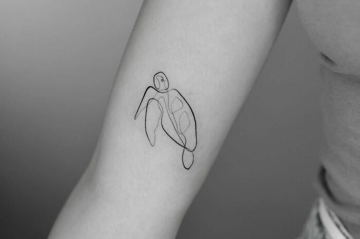 Fine-line perfection tattoo of a single-line turtle design on forearm.
