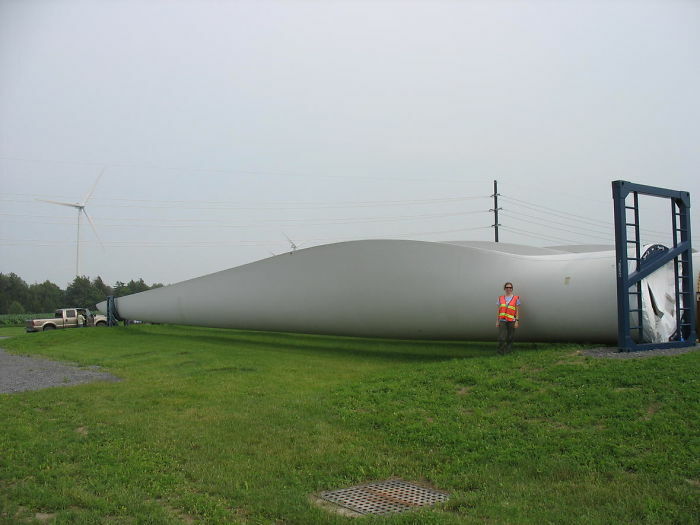 Human Next To Wind Turbine Blade