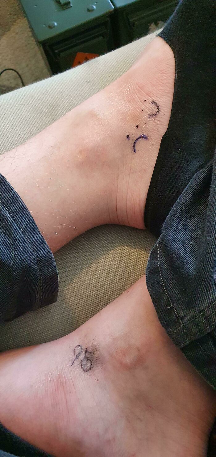 Funny tattoos featuring a smiling and frowning face on the ankle, alongside a scribbled "95" mark.