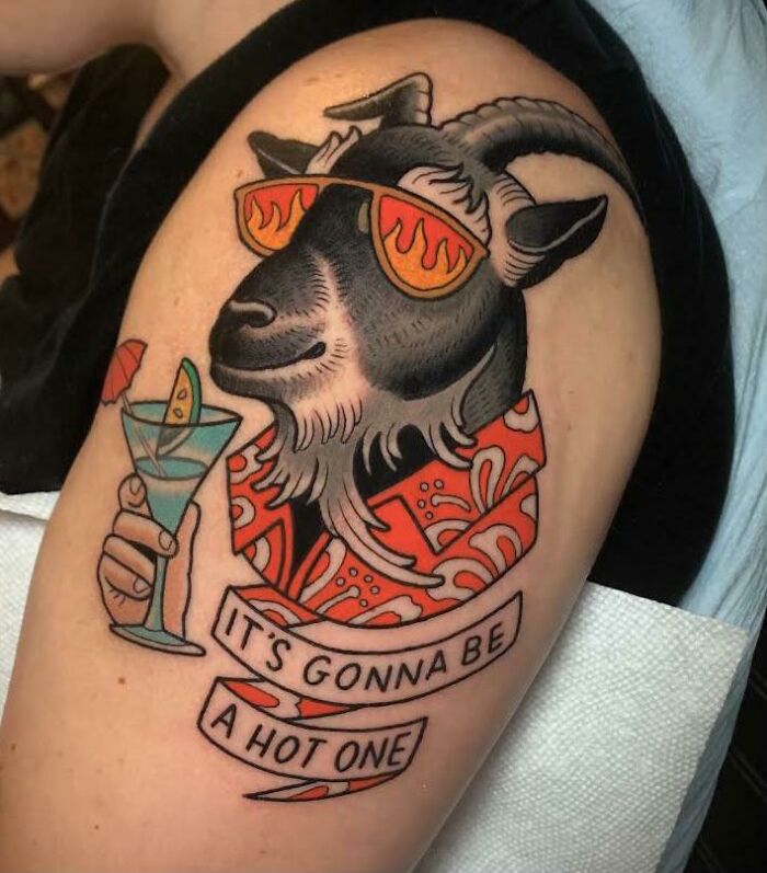 Funny goat tattoo on arm with sunglasses and cocktail, saying "It's gonna be a hot one."