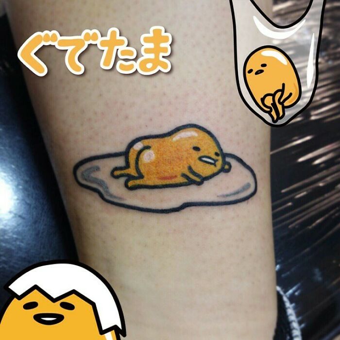 Funny c*****d egg tattoo of a lazy yolk character, adding humor and charm to skin art.