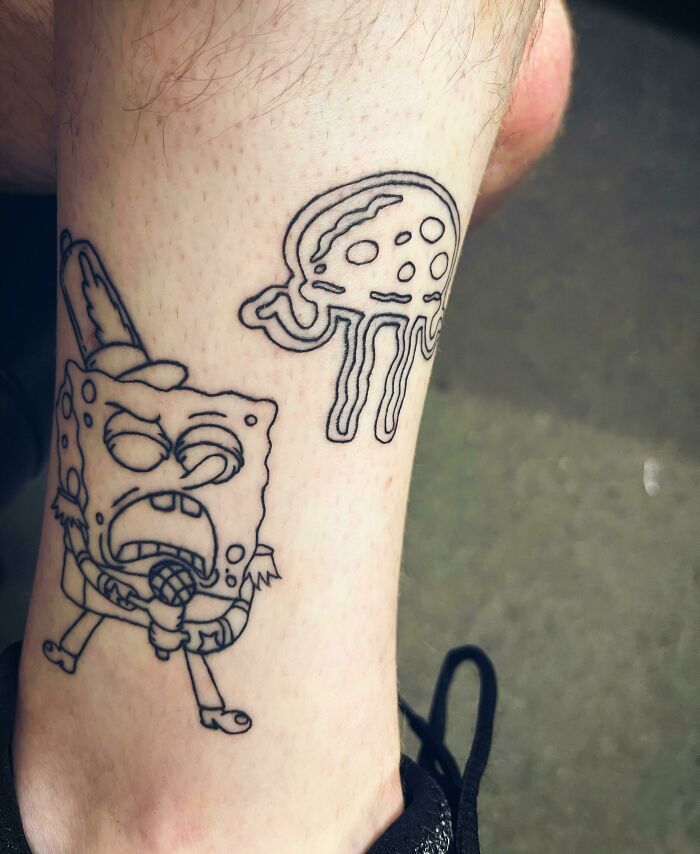 Funny tattoo of SpongeBob singing with a jellyfish on leg; humorous skin art.