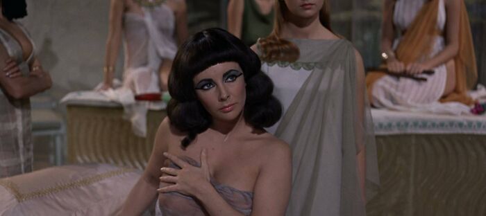 Elizabeth Taylor as Cleopatra covering her body, a famous actress known among celebrities who got married multiple times.
