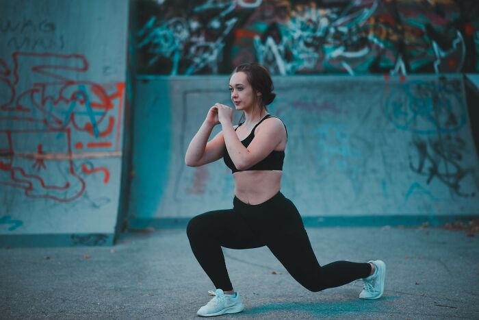 Woman doing exercises in a skate park 
