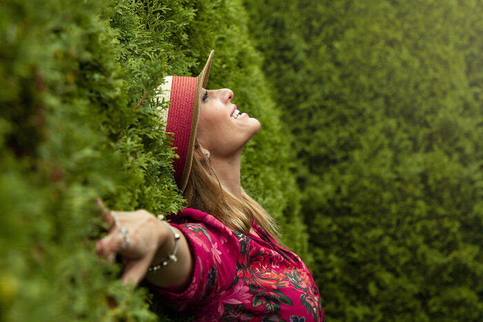 Woman touching a tree and looking up 