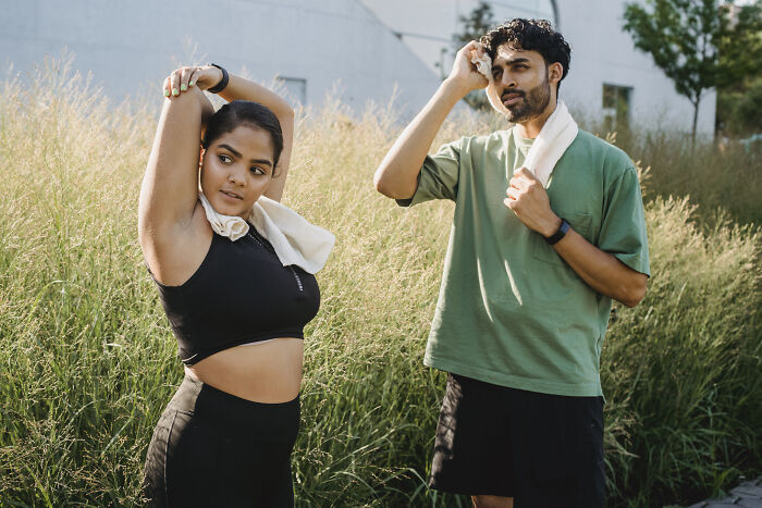 Woman and a man getting ready for a run outside 