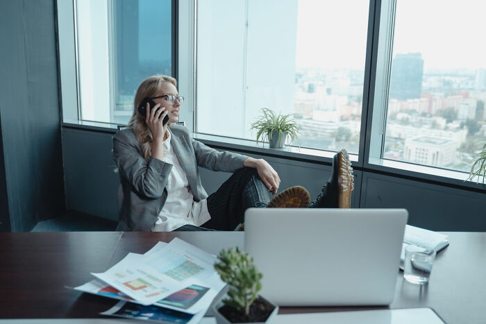 Woman sitting in a chair and talking on the phone 