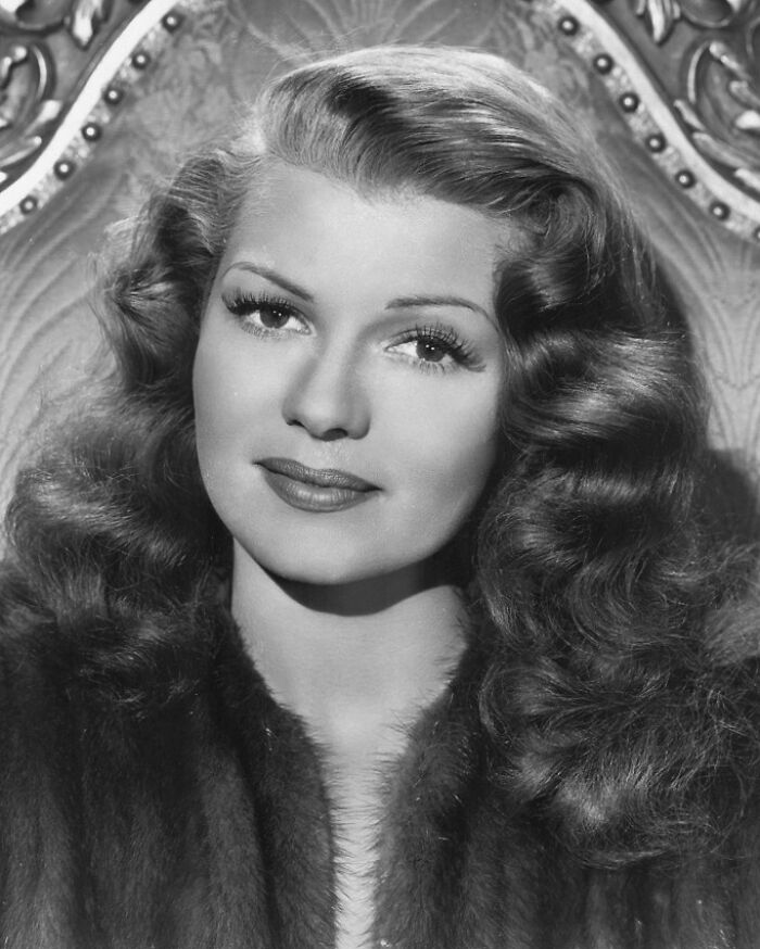 Rita Hayworth wearing a fur, a classic example of famous people who got married multiple times in Hollywood history.
