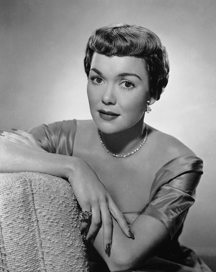 Jane Wyman wearing a gem necklace and elegant dress, representing famous people who got married multiple times.