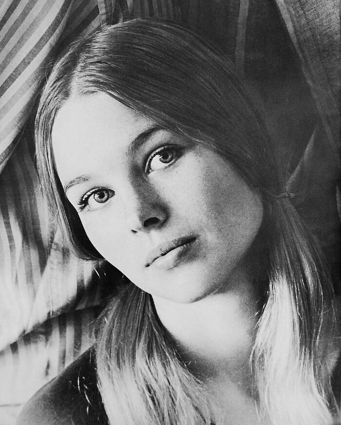 Michelle Phillips with two hair tails in a black and white portrait, one of the famous people who got married multiple times.