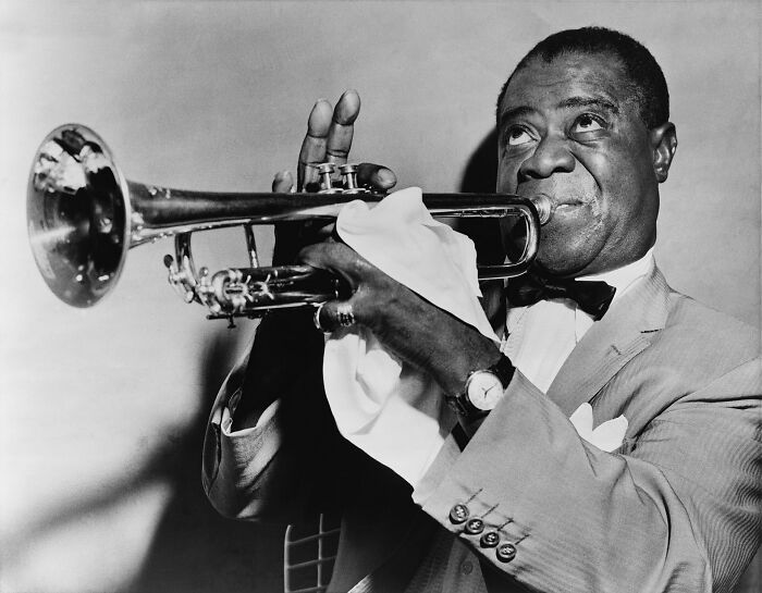 Louis Armstrong playing trumpet, a famous person often noted in lists of celebrities married multiple times.
