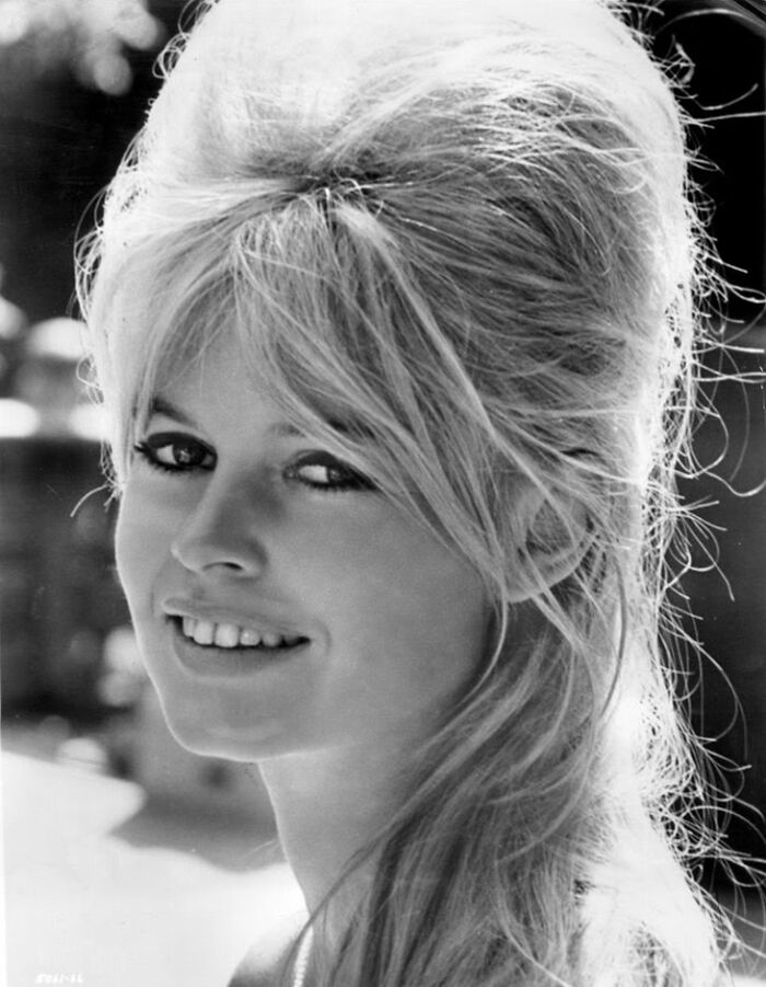 Brigitte Bardot smiling in a black and white portrait, one of the famous people who got married multiple times