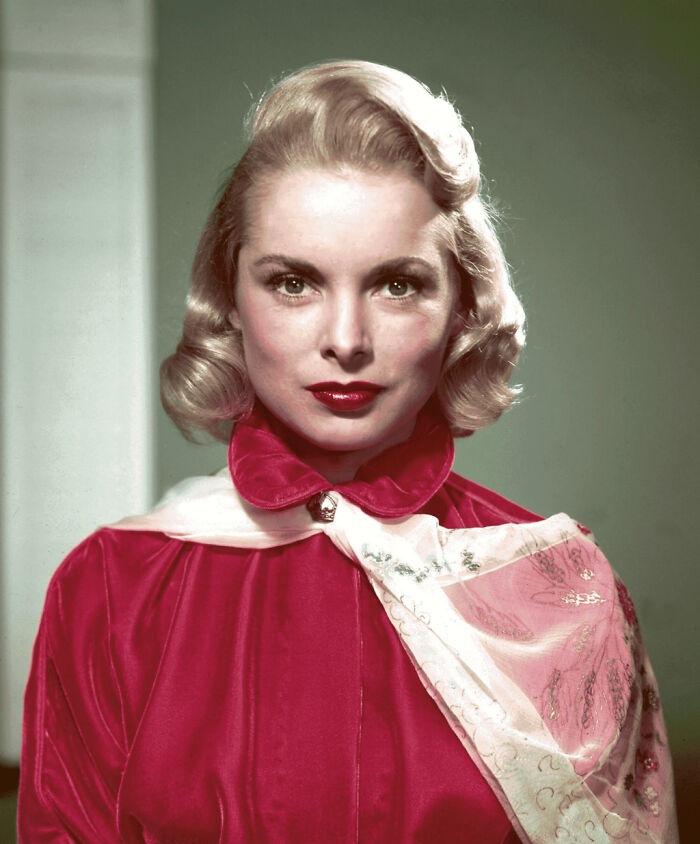 Janet Leigh wearing a red jacket and scarf, a famous person known for multiple marriages in Hollywood history.