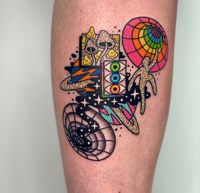 Trippy tattoo featuring colorful abstract shapes and cosmic elements on a person's arm.