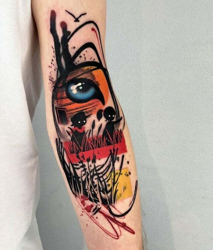Trippy tattoo featuring an abstract eye and surreal design elements on a person's forearm.