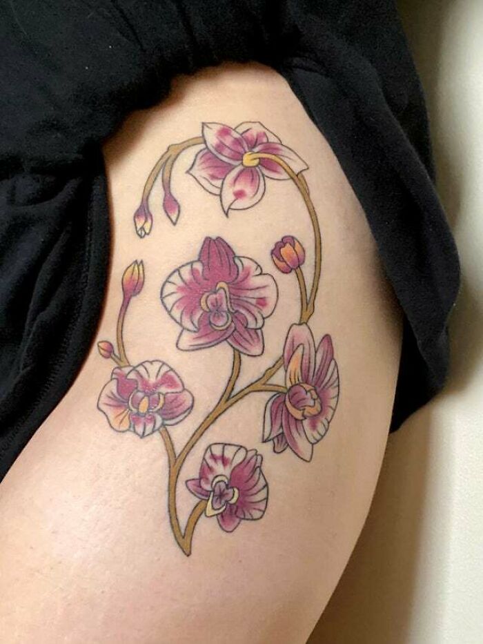 Orchid tattoo design representing the mother-child bond with delicate pink and purple flowers.