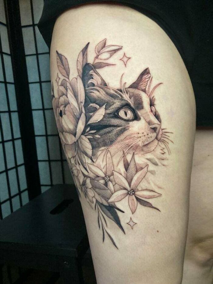 Cat and floral tattoo design on arm celebrating the mother-child bond.