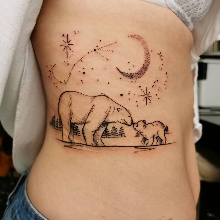 Polar bear and cub tattoo symbolizes the beautiful mom-child bond, set under stars and a crescent moon.