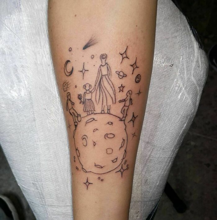 Line art tattoo of a mother and children on a planet, surrounded by stars, symbolizing the mother-child bond.