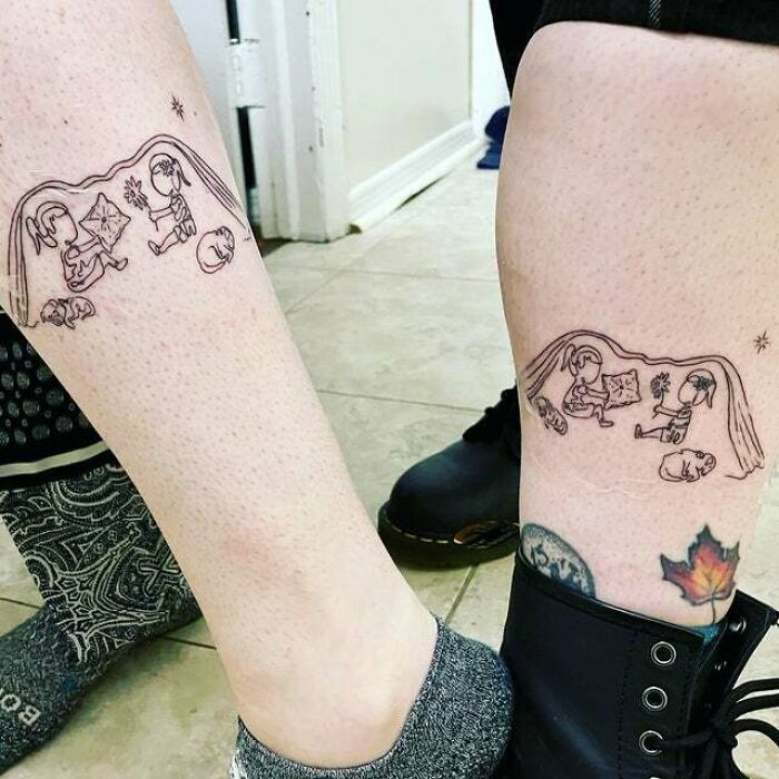 Mother-child bond tattoos on two legs, featuring a delicate line drawing of a mother and child under a blanket.