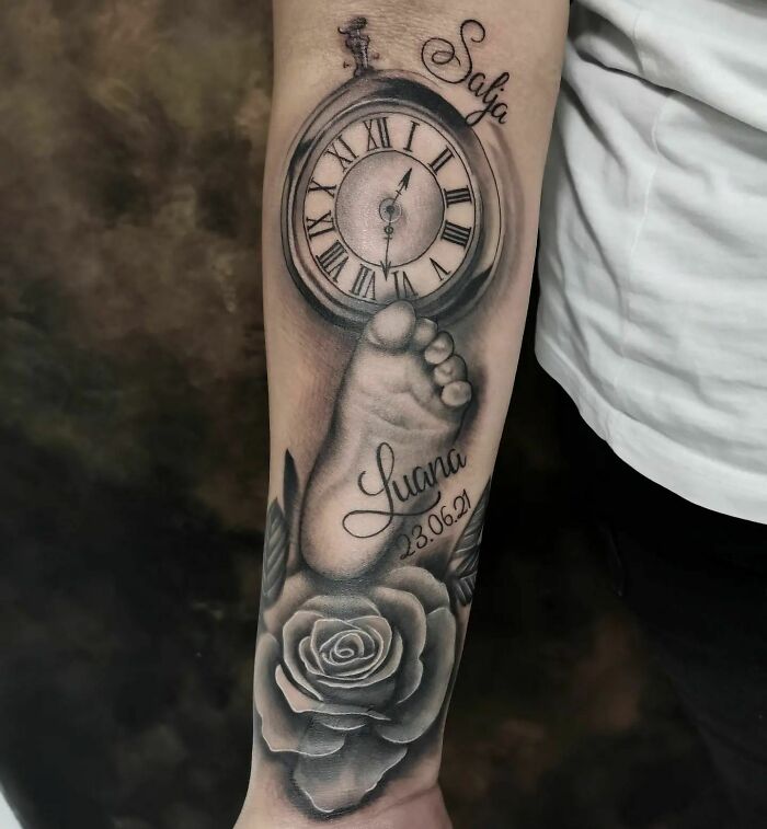 Mom tattoo with a clock, baby footprint, and rose, celebrating the mother-child bond with names and dates.