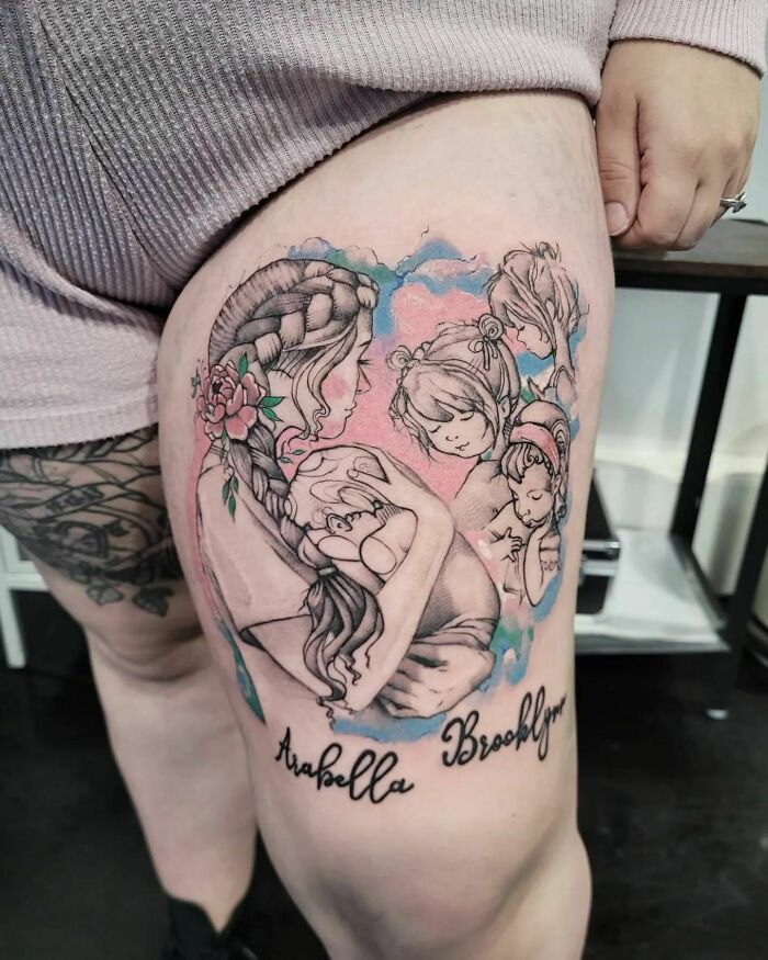 Mother-child bond tattoo on leg, featuring mother with children, accented with floral designs and pastel colors.