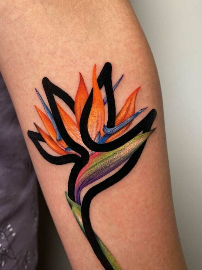 Colorful mom tattoo idea with abstract floral design on arm, celebrating the mother-child bond.