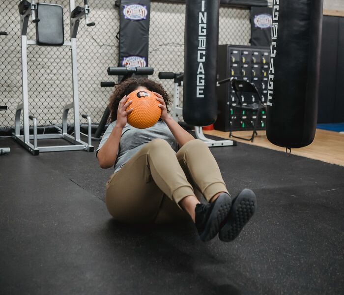 Woman training with a ball on a yoga mat 