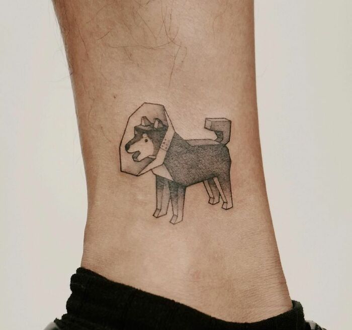 Geometric dog tattoo on ankle, showcasing the bond between humans and pets.