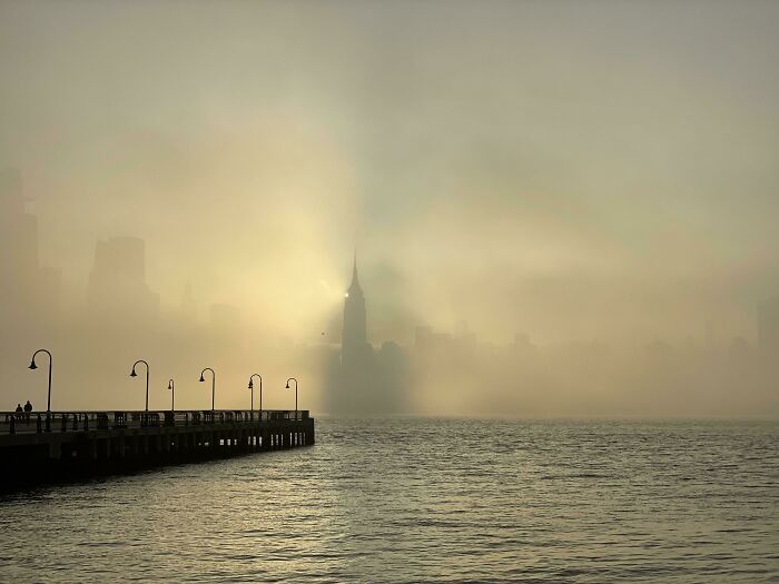 Foggy New York City skyline with Empire State Building visible, showing the city’s unique and captivating atmosphere.